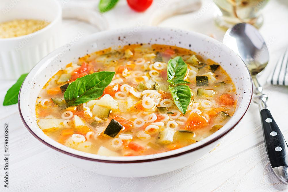 Minestrone, italian vegetable soup with pasta on white table. Vegan soup.