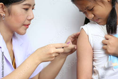 Close-up of doctor making vaccination to the patient on white background Healthy concept