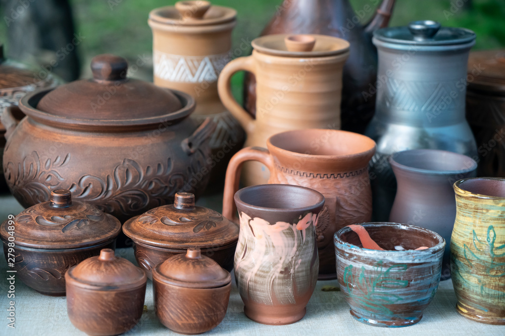 pottery of various shapes and accessories for liquid pouring