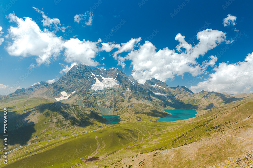 Krishnasar and Vishnusar lakes on the Kashmir great lakes trek in Sonamarg, India. Amazing beauty of Nature. Turquoise lakes/Tarns. Blue sky and white clouds. Wanderlust, hiking, trekking in mountains