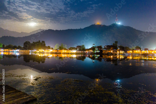 Dal lake (Golden lake) at Srinagar, India as seen on a full moon night with house boats lit up. Shankaracharya temple seen on top of the hills. Beautiful reflection on calm waters. Peaceful kashmir © VIVEK