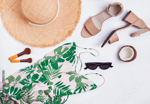 Dress, sandals, hat and other stylish accessories on white background