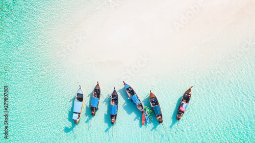 Top view or aerial view of Beautiful crystal clear water and white beach with long tail boats in summer of tropical island or Koh Lipe in Satun,Southern Thailand with copy space 