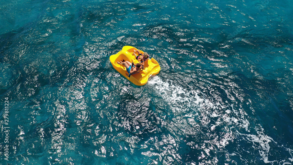 Aerial drone photo of sea bike with couple paddling in tropical exotic turquoise sea