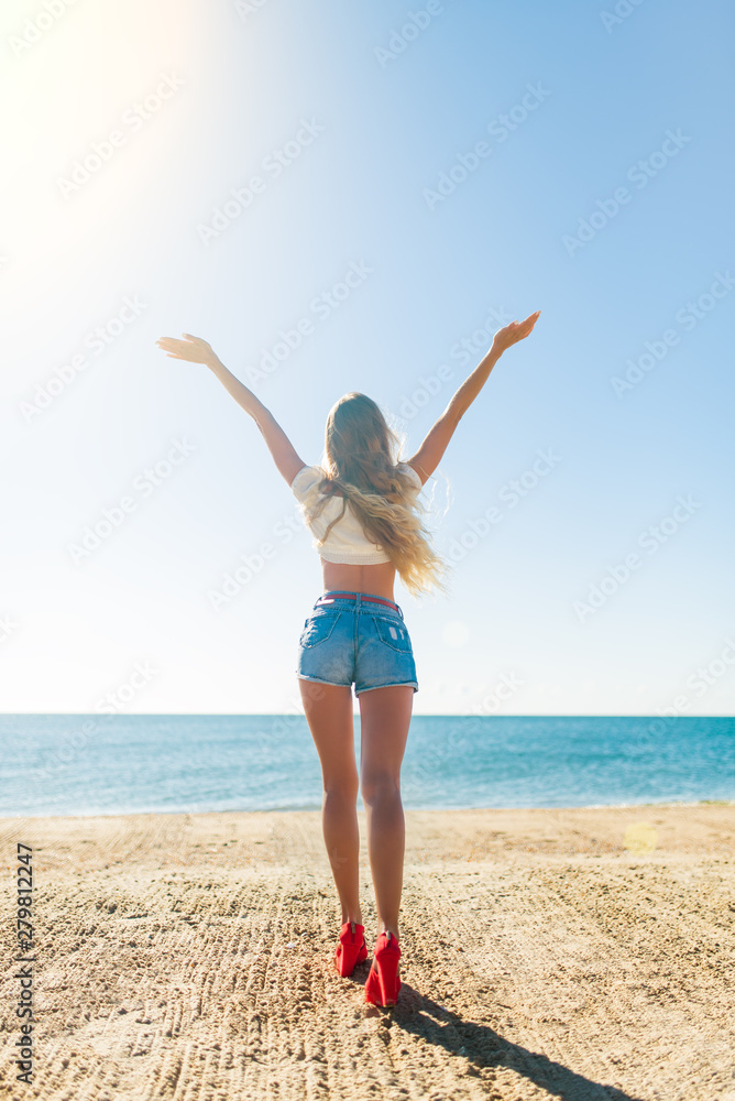 Beautiful bohemian styled and tanned girl at the beach in sunlight Beautiful bohemian styled and tanned girl at the beach in sunlight