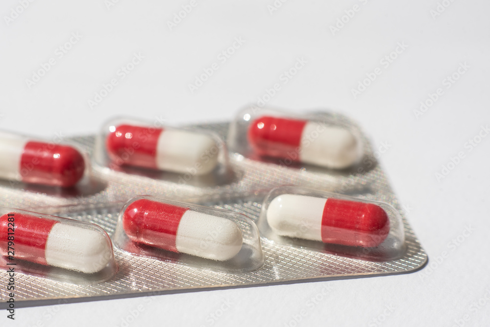 packings of pills and capsules of medicines on white background packings of pills and capsules of medicines on white background