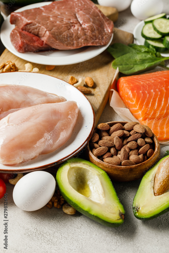 fresh raw salmon, chicken breasts and meat near nuts and avocado, ketogenic diet menu fresh raw salmon, chicken breasts and meat near nuts and avocado, ketogenic diet menu