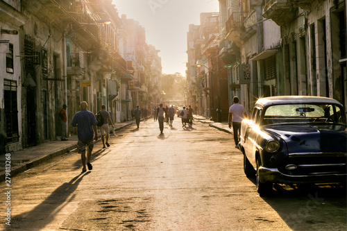 Cuban people in the street of Old Havana going to work with the first lights of the morning, Havana, Cuba