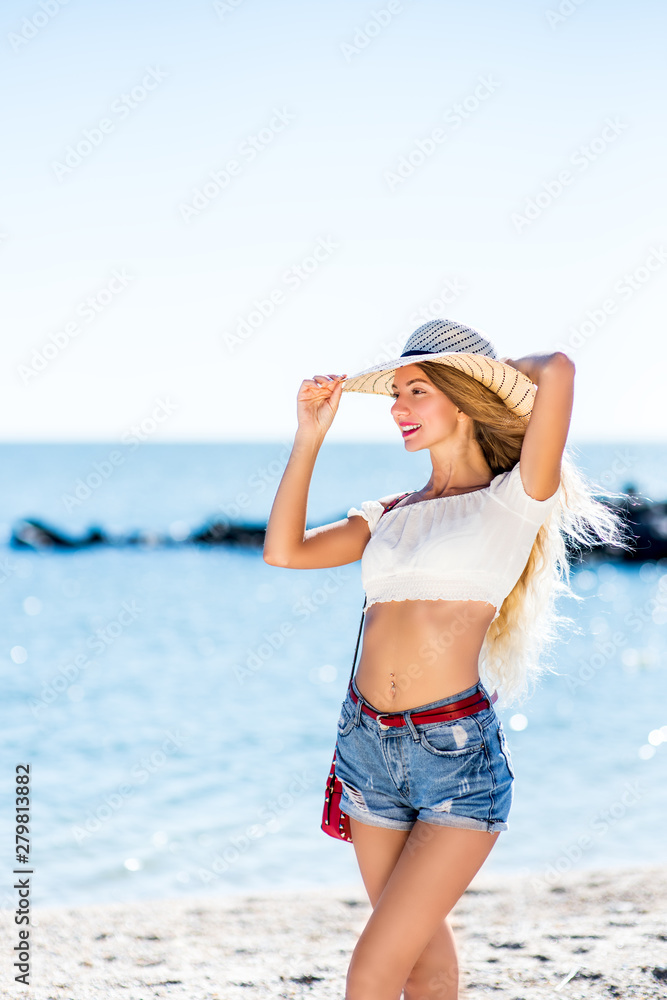 Beautiful bohemian styled and tanned girl at the beach in sunlight Beautiful bohemian styled and tanned girl at the beach in sunlight