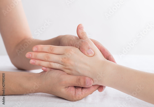 Physiotherapist doing hand massage in medical office