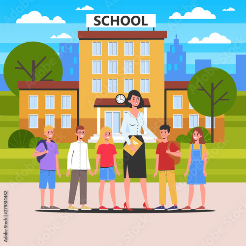 Teacher and pupil standing together in front of the school building