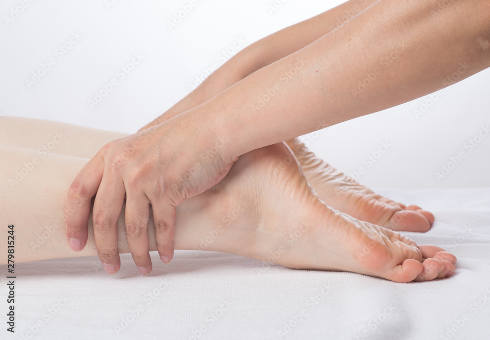 Fototapeta premium Close-up of female hands doing foot massage