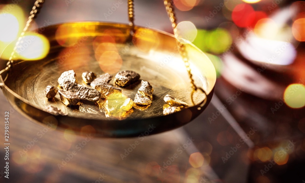 Small gold nuggets in an antique measuring Small gold nuggets in an antique measuring