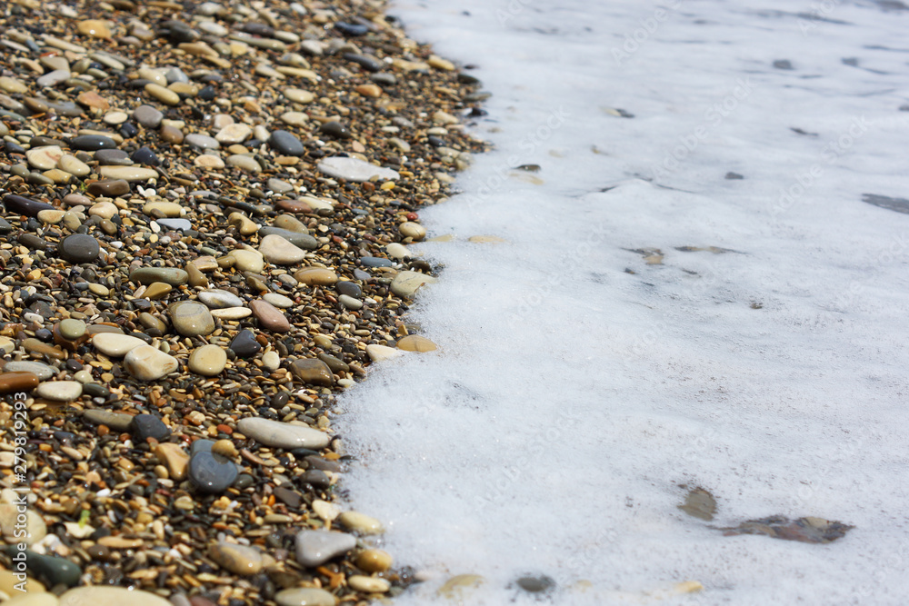 The wave rolls on the rocky shore. The wave rolls on the rocky shore.