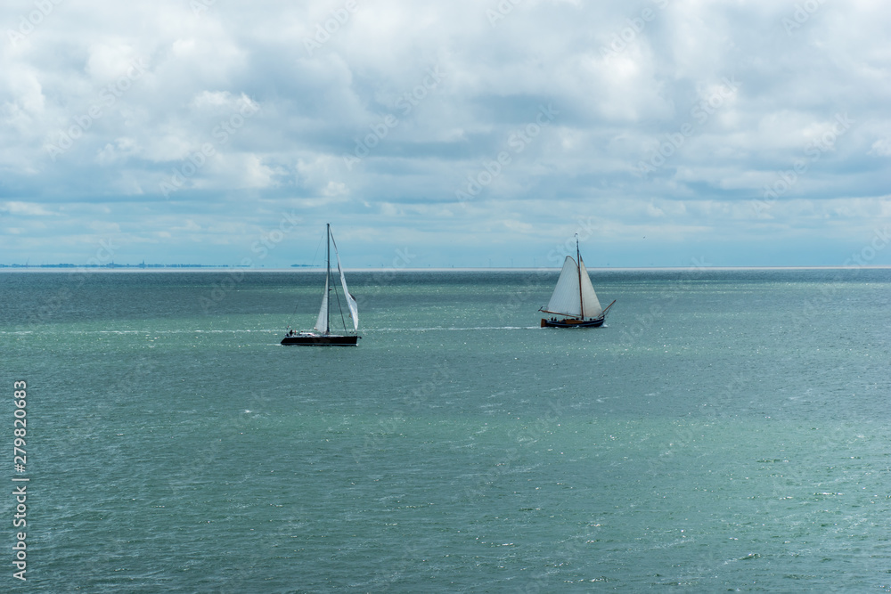 Two sailing boats in the Wadden Sea. The Netherlands, Europe.