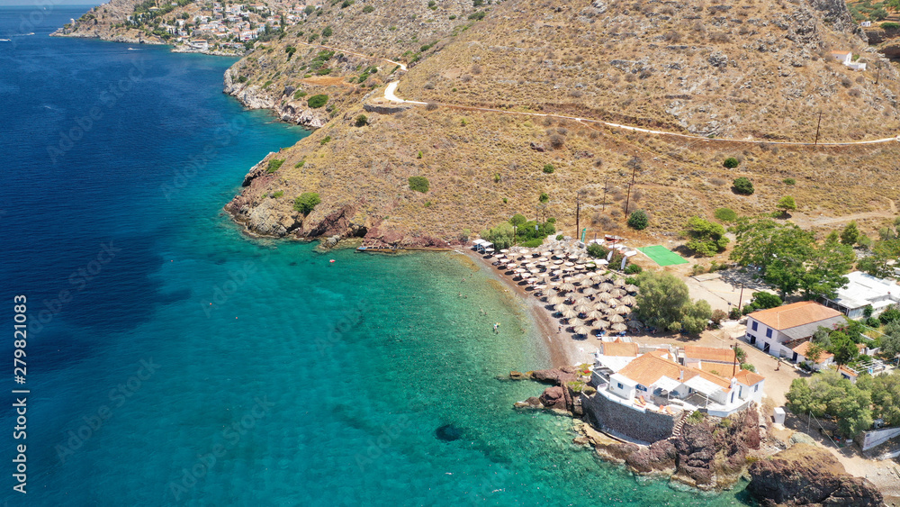Aerial drone photo of small beach of Vlycho with clear turquoise sea in picturesque island of Ydra or Hydra, Saronic gulf, Greece