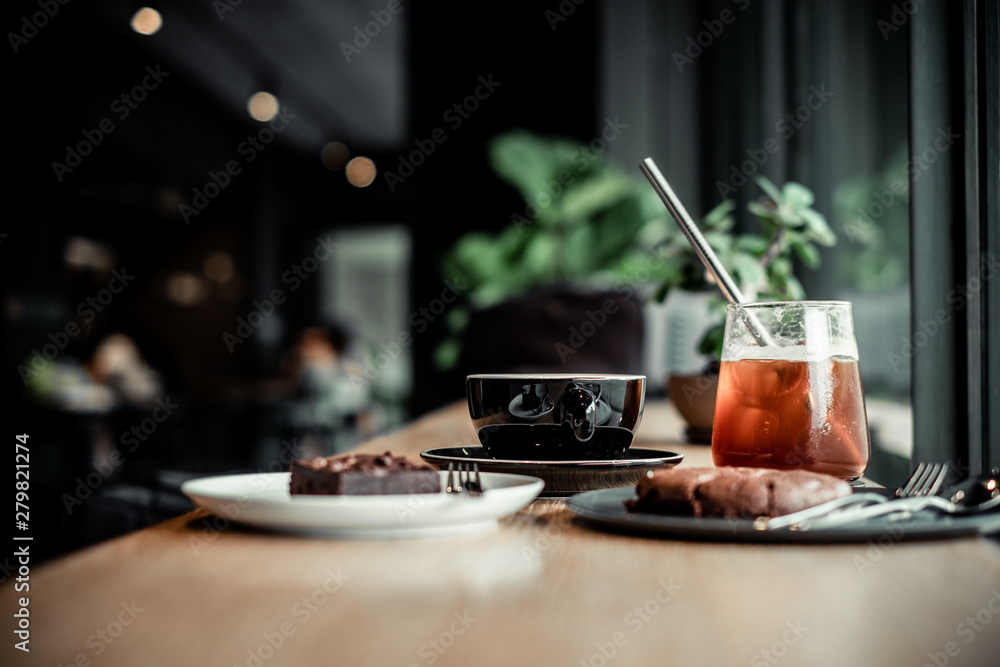 Coffee and bakery beverage on wooden table , coffee shop background