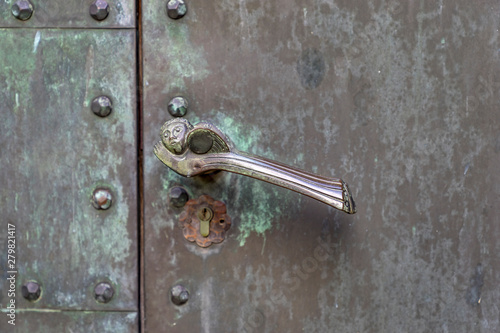 Bronze door handle on a portal entrance to a chapel