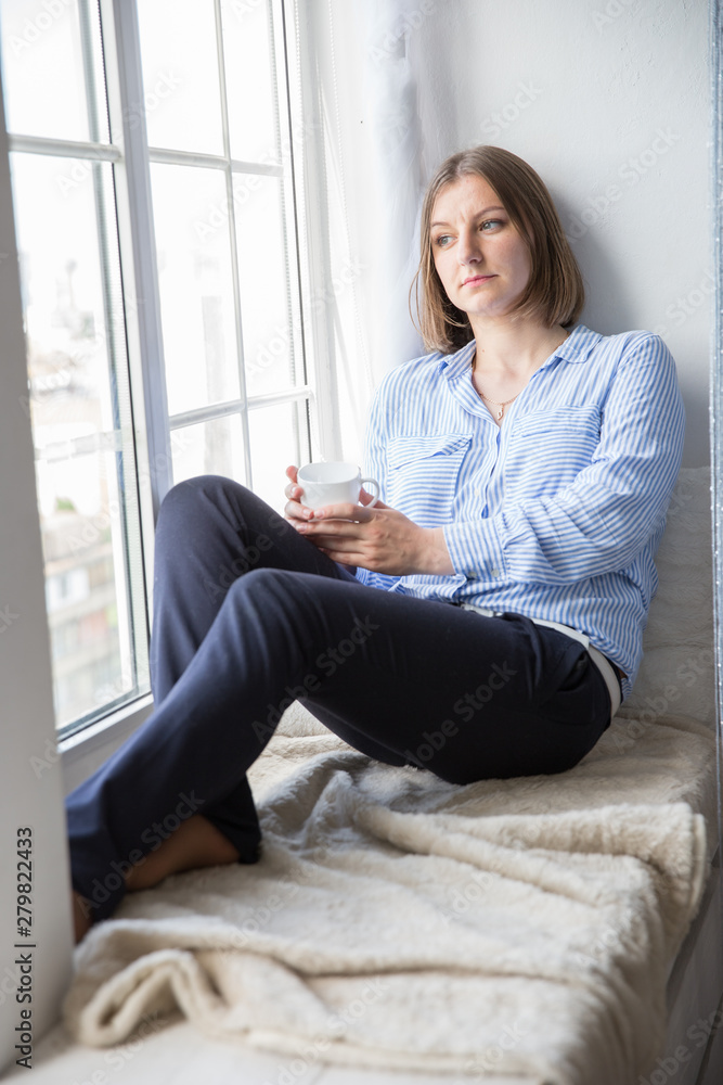 Beautiful Caucasian Woman Sitting by Window Beautiful Caucasian Woman Sitting by Window