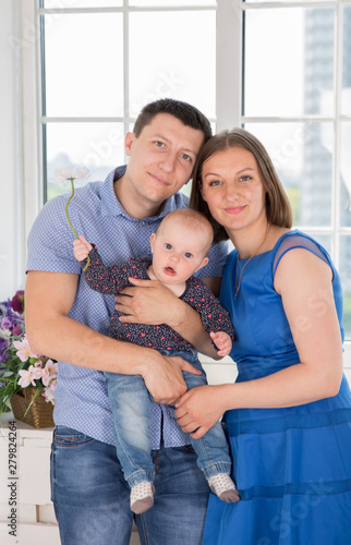 Happy Young Caucasian Family Posing in Studio © Samumneo