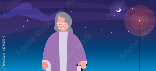 old grandmother with walk stick at night