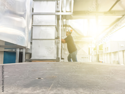 Empty plate with blurred worker and exhaust duct