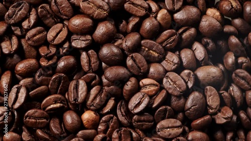 Close up of roasted brown coffee beans rotating. Top view