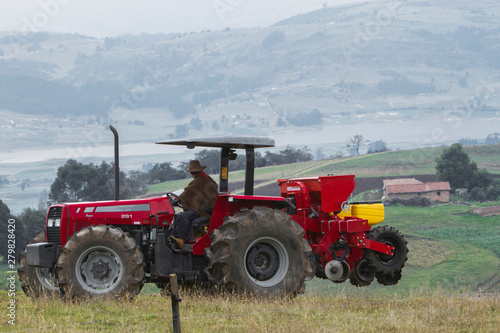 Red tractor working on field