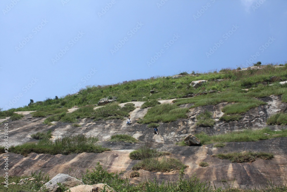 Large rock inspiring hikers outside Bannerghata National Park Bangalore