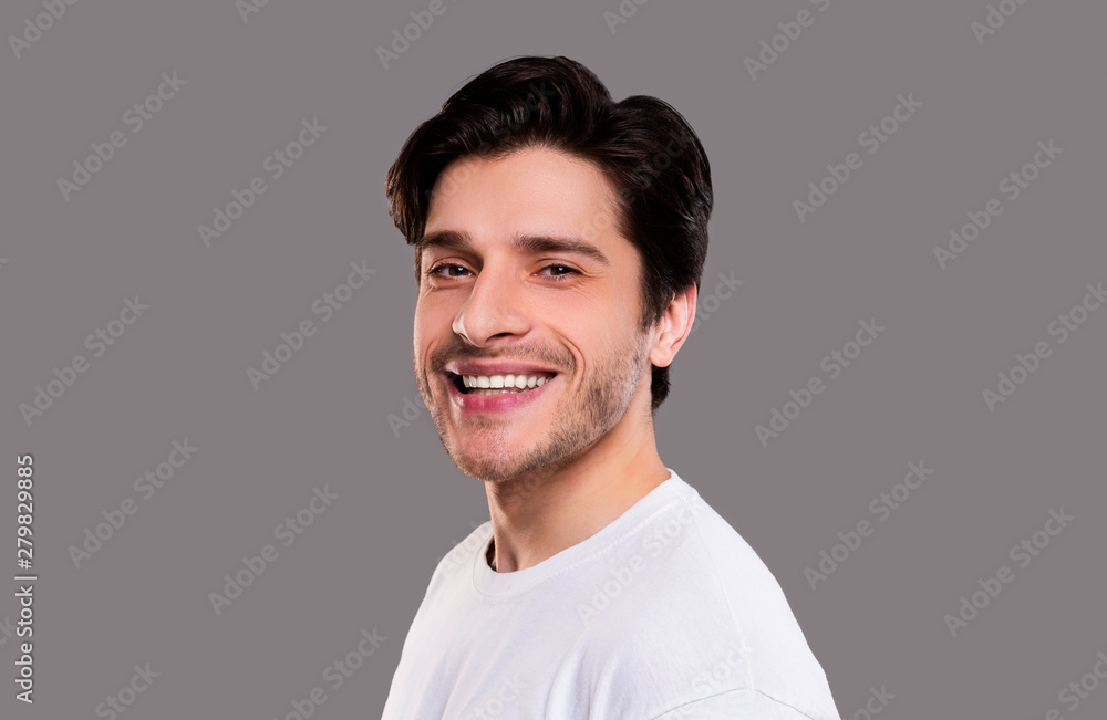 Fototapeta premium Friendly guy widely smiling at camera, semi half portrait