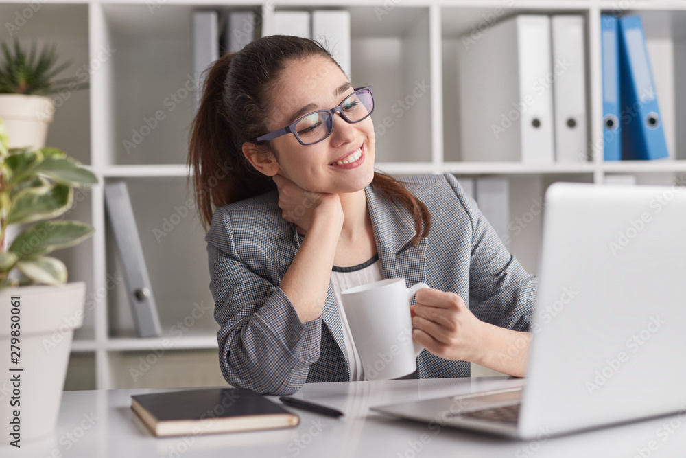 Content young office worker with drink Content young office worker with drink