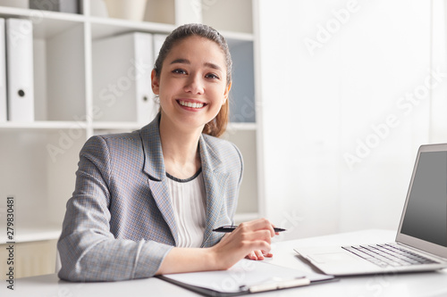 Cheerful office worker with clipboard photo