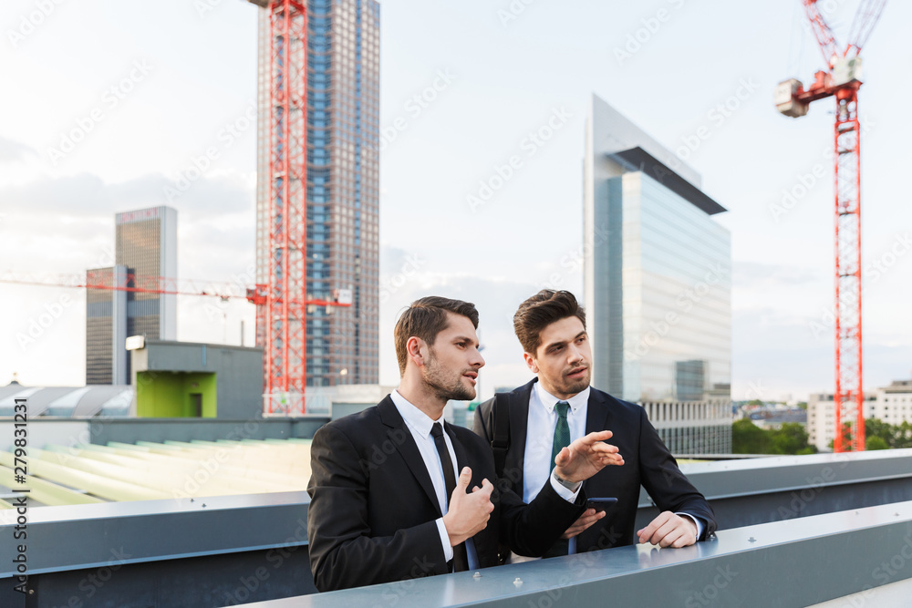 Two attractive young businessmen wearing suits Two attractive young businessmen wearing suits