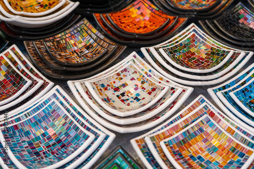 Colorful mosaic decorative plates on the market for sale on local street market in Ubud  island Bali  Indonesia . Souvenirs for tourist