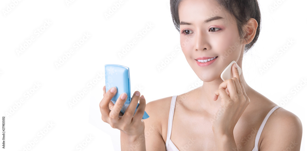 Beautiful Young Asian Woman using Powder, Sponge and Cosmetic on own face. Cosmetologist, Skin care or Beauty concept Beautiful Young Asian Woman using Powder, Sponge and Cosmetic on own face. Cosmetologist, Skin care or Beauty concept