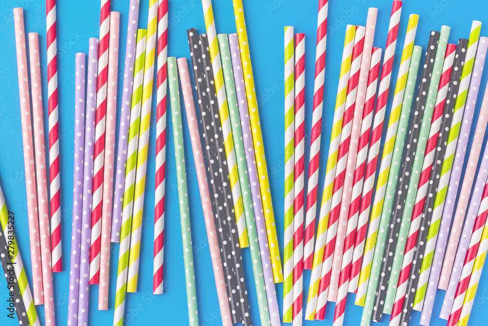 Background of Colored Paper Drink Straws on Blue Background Party Holidays Concept Flat Lay Top View