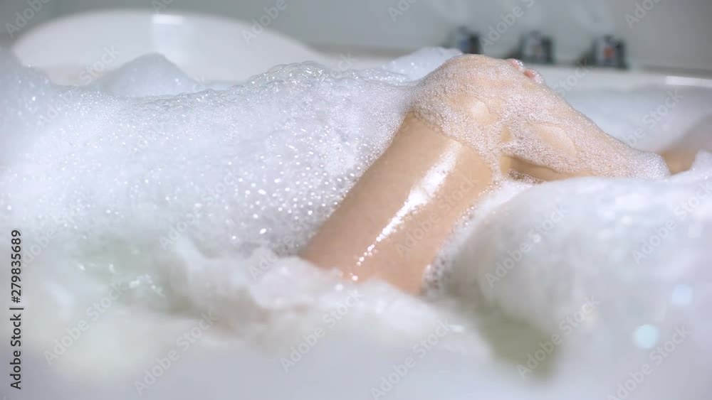 Woman enjoying bathing in whirlpool with foam bubbles, relaxation, skin care Woman enjoying bathing in whirlpool with foam bubbles, relaxation, skin care