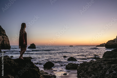 Young woman admiring the tropical sunset