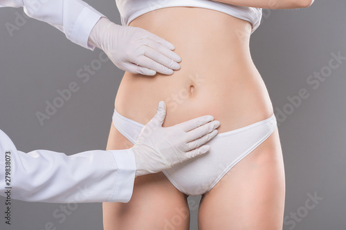 Young woman getting consultation at plastic surgery clinic