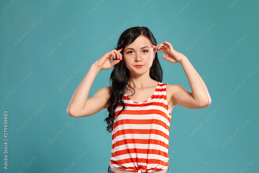 Studio photo of a gorgeous girl teenager posing over a blue background. Studio photo of a gorgeous girl teenager posing over a blue background.