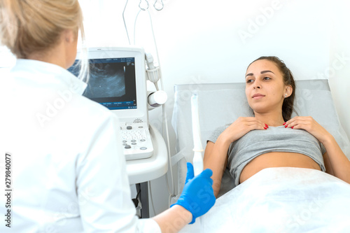 The gynecologist sets up the ultrasound machine and explains to the patient how the study will be performed. Ultrasound of the pelvic organs
