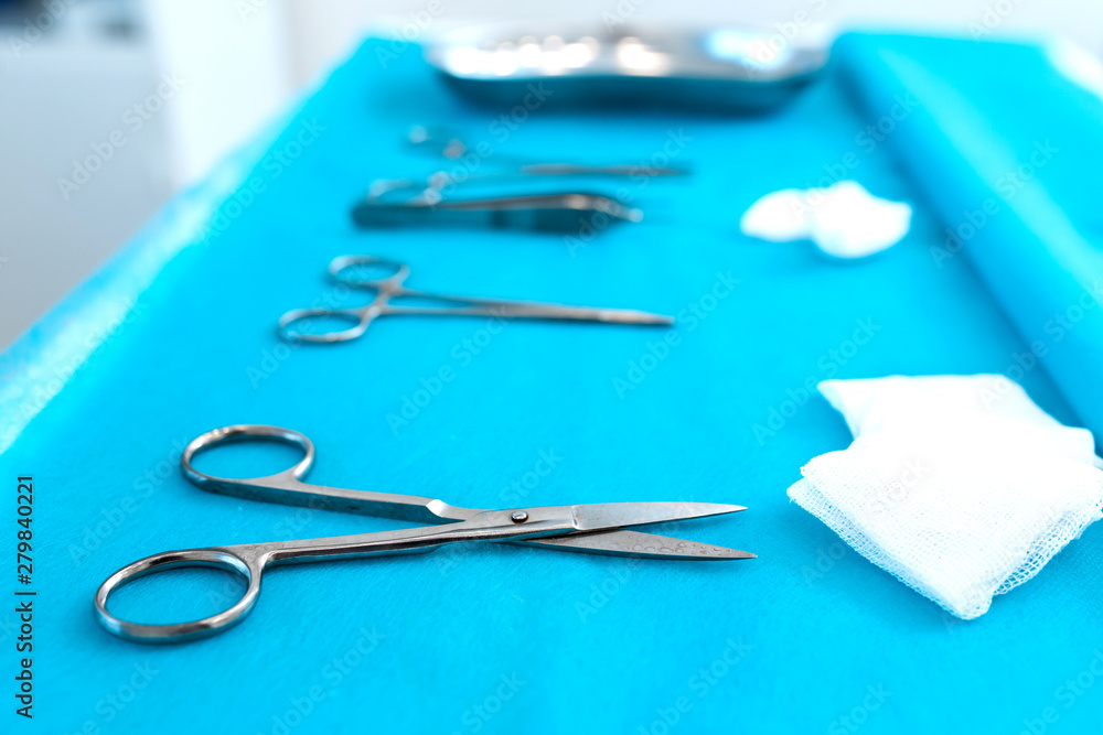 the nurse is laying out a sterile instrument for operating on the table the nurse is laying out a sterile instrument for operating on the table