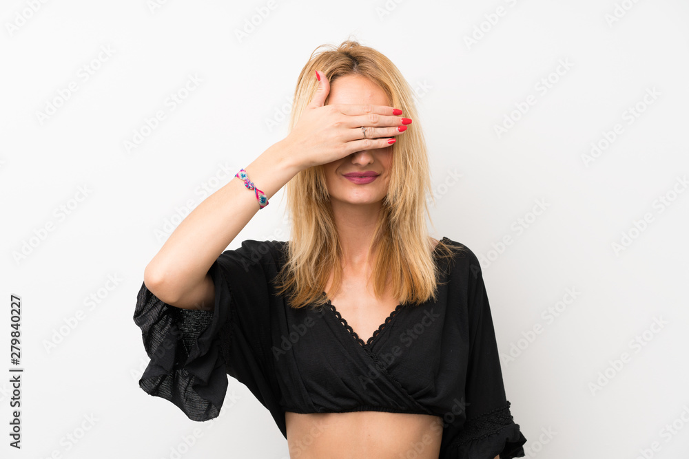 Young blonde woman over isolated white wall covering eyes by hands. Do not want to see something Young blonde woman over isolated white wall covering eyes by hands. Do not want to see something