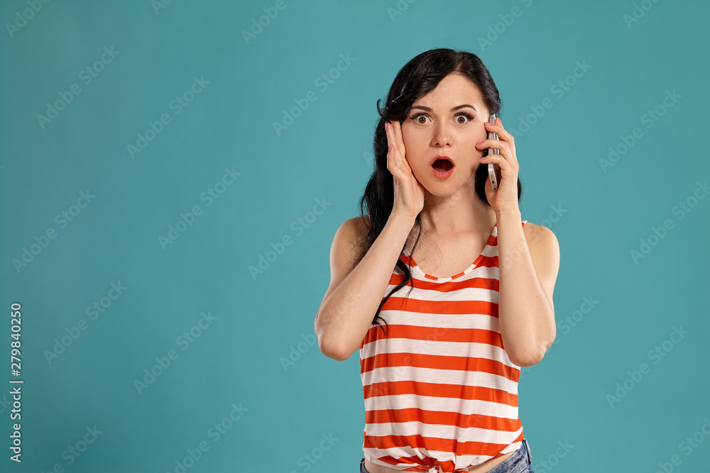Studio photo of a gorgeous girl teenager posing over a blue background. Studio photo of a gorgeous girl teenager posing over a blue background.