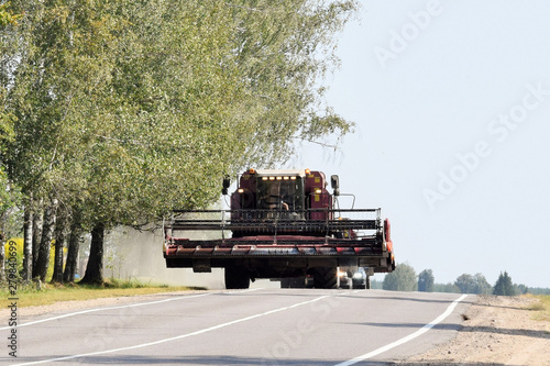 Obraz na plátně modern combine harvester moves by road