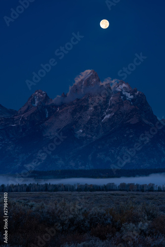 Full Moon Sets over the Tetons and Illuminates Clouds on the Summit