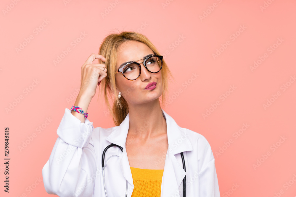 Young blonde doctor woman having doubts and with confuse face expression