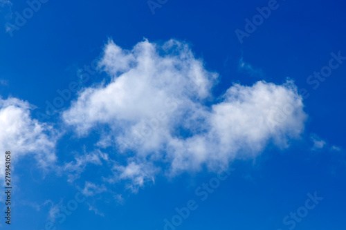 Background of a one single cumulus cloud with a blue clear sky photo