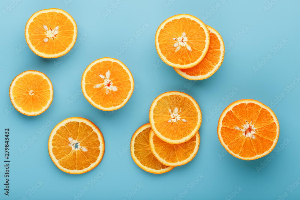 Slices and slices of orange pulp on a bright blue background as a textural background, the substrate. Full screen Flat lay, top view. Food background Slices and slices of orange pulp on a bright blue background as a textural background, the substrate. Full screen Flat lay, top view. Food background