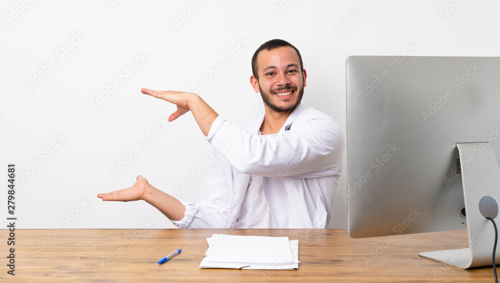 Doctor Colombian man holding copyspace to insert an ad